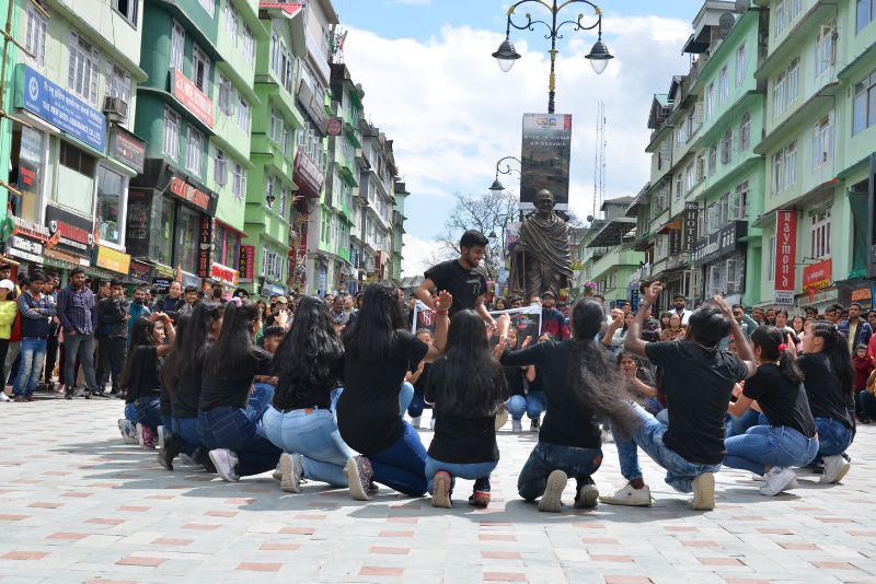 A photo of the bustling streets of MG Marg in Gangtok, with people gathering to watch the flashmob of NIT Sikkim Students, Udgam 2023 National Institute of Technology Sikkim