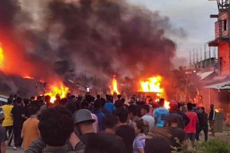 Image showing fire,  police and mob gathering at Manipur violence