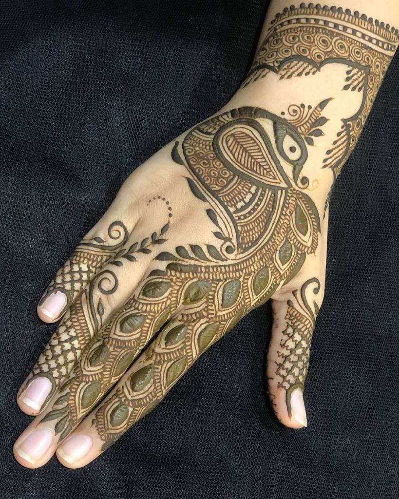 Classic peacock motif in traditional back hand mehndi